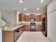 Functional kitchen showcasing sleek black appliances, ample cabinetry, and a convenient breakfast bar at 12973 Dream Catcher Way, Riverview, FL 33579