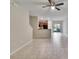 Spacious living area with tile floors leading into an open kitchen at 12973 Dream Catcher Way, Riverview, FL 33579