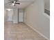 Bright and airy living room with neutral walls, tile flooring, and seamless transition to other living spaces at 12973 Dream Catcher Way, Riverview, FL 33579