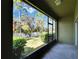A screened patio with a view to the fenced yard, trees, and blue sky at 12973 Dream Catcher Way, Riverview, FL 33579