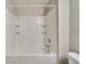 Bathroom featuring a shower-tub combo with a white shower surround and shower caddy at 12973 Dream Catcher Way, Riverview, FL 33579