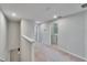 Well-lit upstairs hallway with carpet and access to laundry room at 12973 Dream Catcher Way, Riverview, FL 33579