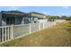 This backyard boasts a screened-in lanai and is bordered by a well-kept fence for serene outdoor enjoyment at 13192 Royal Pines Ave, Riverview, FL 33579