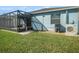 A backyard area shows a screened-in lanai, manicured lawn, and privacy fence, creating an inviting outdoor space at 13192 Royal Pines Ave, Riverview, FL 33579