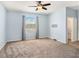 Light-filled bedroom includes a ceiling fan, carpet, and an adjacent walk-in closet at 13192 Royal Pines Ave, Riverview, FL 33579