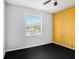 This is a vibrant bedroom with gray and yellow walls, a ceiling fan, and a window with horizontal blinds at 13192 Royal Pines Ave, Riverview, FL 33579