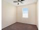 Compact bedroom includes a ceiling fan, carpet, and a single window at 13192 Royal Pines Ave, Riverview, FL 33579