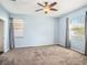 Bright bedroom featuring neutral walls, ceiling fan, and carpeted floor at 13192 Royal Pines Ave, Riverview, FL 33579