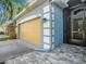 Close-up of the home's exterior showcasing the attached garage, paver entryway, and blue and white accents at 13192 Royal Pines Ave, Riverview, FL 33579