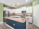 Modern kitchen featuring white cabinetry, granite countertops, stainless steel appliances, and an island with bar seating at 13192 Royal Pines Ave, Riverview, FL 33579