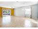 Bright living area with tile floors, sliding door to the screened lanai, and ceiling fan for relaxed comfort at 13192 Royal Pines Ave, Riverview, FL 33579