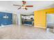 Open concept living space with tile floors, colorful walls, and a kitchen island, perfect for modern living at 13192 Royal Pines Ave, Riverview, FL 33579