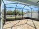 This screened-in patio features neutral pavers, a ceiling fan, and backyard views, framed by a white privacy fence at 13192 Royal Pines Ave, Riverview, FL 33579