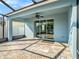 A screened-in patio features paver flooring, ceiling fan, and sliding door access to the home's interior spaces at 13192 Royal Pines Ave, Riverview, FL 33579