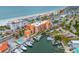 Stunning aerial view of the building, beach, and marina, showcasing the desirable coastal location at 13235 Gulf Blvd # 306, Madeira Beach, FL 33708