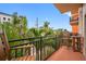 Balcony view surrounded by lush greenery, offering a relaxing outdoor space with seating at 13235 Gulf Blvd # 306, Madeira Beach, FL 33708