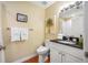 Bathroom featuring a marble countertop, and a tropical palm tree artwork at 13235 Gulf Blvd # 306, Madeira Beach, FL 33708