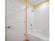 Clean and well-lit bathroom featuring a white-tiled shower and tub at 13235 Gulf Blvd # 306, Madeira Beach, FL 33708