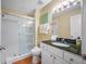 Bathroom showcases a stand-up shower with glass doors, granite countertop, and updated fixtures at 13235 Gulf Blvd # 306, Madeira Beach, FL 33708