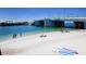 Scenic beach view with a bridge, clear turquoise waters, and people enjoying water activities at 13235 Gulf Blvd # 306, Madeira Beach, FL 33708