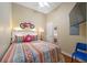 Cozy bedroom featuring a decorative bike, colorful bedding, and a bright, inviting atmosphere at 13235 Gulf Blvd # 306, Madeira Beach, FL 33708