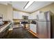 Modern kitchen features granite countertops, stainless steel appliances, and ample cabinet space at 13235 Gulf Blvd # 306, Madeira Beach, FL 33708
