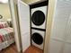 Laundry closet featuring a stacked washer and dryer unit for efficient in-home convenience at 13235 Gulf Blvd # 306, Madeira Beach, FL 33708