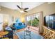 Comfortable living room featuring a plush sofa, an area rug, and balcony access with views at 13235 Gulf Blvd # 306, Madeira Beach, FL 33708