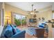 Open living room with sliding glass doors leading to a balcony overlooking tropical foliage at 13235 Gulf Blvd # 306, Madeira Beach, FL 33708