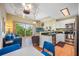 Cozy living room featuring a sliding door to the balcony, a TV, and comfortable furniture at 13235 Gulf Blvd # 306, Madeira Beach, FL 33708