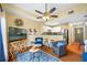 Comfortable living room with TV, stylish decor, and an open floor plan connecting to the kitchen with stainless appliances at 13235 Gulf Blvd # 306, Madeira Beach, FL 33708