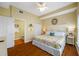 Cozy bedroom with en-suite bathroom featuring a large bed, light walls, and ample natural light at 13235 Gulf Blvd # 306, Madeira Beach, FL 33708