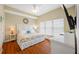 Bright main bedroom with bed, large window and white dresser and night stands at 13235 Gulf Blvd # 306, Madeira Beach, FL 33708