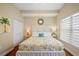 Bright bedroom featuring large bed, white furniture and a palm tree painting for a relaxing, beachy feel at 13235 Gulf Blvd # 306, Madeira Beach, FL 33708
