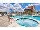 Community pool features a jacuzzi and ample seating for residents and guests at 13235 Gulf Blvd # 306, Madeira Beach, FL 33708