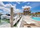 Community pool near the marina featuring comfortable lounge chairs at 13235 Gulf Blvd # 306, Madeira Beach, FL 33708