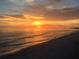 Breathtaking sunset view over the ocean with vibrant orange and yellow hues reflecting on the water at 13235 Gulf Blvd # 306, Madeira Beach, FL 33708