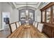 Elegant dining room with a rustic farmhouse table and a beautiful chandelier at 1446 Jumana Loop, Apollo Beach, FL 33572