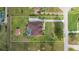Expansive aerial view of the property showcasing a well-maintained home, pool, and large yard with mature trees at 14739 Vista View Ct, Dade City, FL 33523