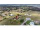 Expansive aerial view of a luxury home featuring a private pool and lush landscaping in a serene countryside setting at 14739 Vista View Ct, Dade City, FL 33523