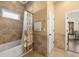 Bathroom featuring neutral tile, tub and shower with curtains, and access to the bedroom at 14739 Vista View Ct, Dade City, FL 33523