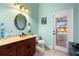 Charming bathroom with a mosaic mirror, granite countertop, and access to the outdoor pool area at 14739 Vista View Ct, Dade City, FL 33523