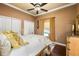 Bedroom featuring ceiling fan, decorative curtains, and hard wood floors at 14739 Vista View Ct, Dade City, FL 33523