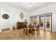 Dining area with a glass table, chandelier, wood chairs, and french doors with natural light at 14739 Vista View Ct, Dade City, FL 33523