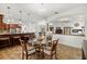 Open concept living area with a dining table, kitchen bar, and access to other living spaces at 14739 Vista View Ct, Dade City, FL 33523