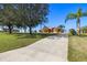 View of home showcasing driveway leading up to home with a luscious green front yard at 14739 Vista View Ct, Dade City, FL 33523