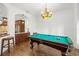 Recreational space with a pool table, hardwood floors, and stylish lighting at 14739 Vista View Ct, Dade City, FL 33523