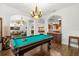 View of the game room featuring a pool table, hardwood floors, and open to the living room at 14739 Vista View Ct, Dade City, FL 33523