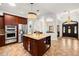 Gourmet kitchen featuring stainless steel appliances, granite countertops, and a center island at 14739 Vista View Ct, Dade City, FL 33523