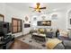 Comfortable living room with hardwood floors, a fireplace, and a ceiling fan at 14739 Vista View Ct, Dade City, FL 33523